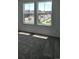 Bright bedroom featuring large windows that overlook a well-maintained neighborhood at 6077 Idlewild Pl, Brighton, CO 80601