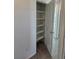 New walk-in closet with shelving and an open door at 6077 Idlewild Pl, Brighton, CO 80601