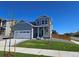 Charming two-story home featuring a well-maintained lawn, a two-car garage, and a welcoming entrance at 6077 Idlewild Pl, Brighton, CO 80601