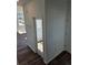 Hallway with wood floors, white trim, and neutral paint colors at 6077 Idlewild Pl, Brighton, CO 80601