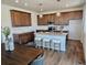 Bright kitchen featuring a central island with seating, stainless appliances, and sleek countertops at 6077 Idlewild Pl, Brighton, CO 80601
