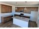 Modern kitchen features stylish cabinets, an island with sink, and stainless steel appliances at 6077 Idlewild Pl, Brighton, CO 80601
