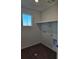 New laundry room with tile flooring, a window, and laundry hookups ready for appliances at 6077 Idlewild Pl, Brighton, CO 80601