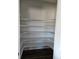 Spacious walk-in pantry with white shelving providing ample storage for food and kitchen essentials at 6077 Idlewild Pl, Brighton, CO 80601