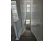 Well-lit staircase featuring a white handrail and multiple windows overlooking the neighborhood at 6077 Idlewild Pl, Brighton, CO 80601