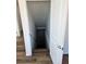 Stairwell leading to the basement with hardwood floors, white walls, and a white railing at 6077 Idlewild Pl, Brighton, CO 80601