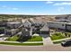 An elevated shot of a modern home with healthy green grass and fresh landscaping at 2230 Rim Ridge Dr, Castle Pines, CO 80108