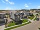 Aerial view of a modern home with a well-manicured front yard and a view of the community at 2230 Rim Ridge Dr, Castle Pines, CO 80108