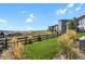 View of the backyard featuring a wooden fence and lush green grass at 2230 Rim Ridge Dr, Castle Pines, CO 80108