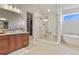 Bright bathroom with double vanity, marble shower with bench, and soaking tub at 2230 Rim Ridge Dr, Castle Pines, CO 80108