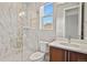 Elegant bathroom with walk-in shower, white marble tiles, and modern vanity at 2230 Rim Ridge Dr, Castle Pines, CO 80108