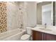 Bright bathroom featuring a modern vanity, tub, and tiled accent wall at 2230 Rim Ridge Dr, Castle Pines, CO 80108