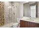 Bathroom with walk-in shower, hexagon tile accent and modern vanity at 2230 Rim Ridge Dr, Castle Pines, CO 80108