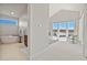Spacious main bedroom leading to luxurious ensuite bathroom with soaking tub and large windows with picturesque views at 2230 Rim Ridge Dr, Castle Pines, CO 80108