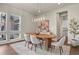 Dining room filled with natural light features a stylish light fixture and view to living room at 2230 Rim Ridge Dr, Castle Pines, CO 80108
