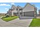 Wide driveway leading to an attached two-car garage, providing ample parking space for residents and guests at 2230 Rim Ridge Dr, Castle Pines, CO 80108
