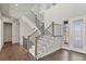 Bright entryway with hardwood floors, staircase, and stylish railing design at 2230 Rim Ridge Dr, Castle Pines, CO 80108