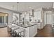 Large kitchen island with seating, modern appliances, and stylish pendant lights, perfect for meal prep and casual dining at 2230 Rim Ridge Dr, Castle Pines, CO 80108
