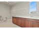 Functional laundry room featuring ample counter space, cabinetry, and natural light at 2230 Rim Ridge Dr, Castle Pines, CO 80108