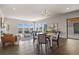 Bright living room boasts dark hardwood floors, modern lighting, and expansive windows overlooking the landscape at 2230 Rim Ridge Dr, Castle Pines, CO 80108
