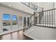 Open staircase featuring hardwood floors, metal railings, and plenty of natural light at 2230 Rim Ridge Dr, Castle Pines, CO 80108