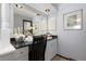 Bathroom vanity with a large mirror and cabinet storage space below at 3752 S Rosemary Way, Denver, CO 80237