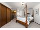 Spacious carpeted bedroom with a four poster bed near closet and doorway at 3752 S Rosemary Way, Denver, CO 80237