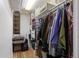 Walk-in closet with shelving, storage bins and hanging clothes on a rod at 3752 S Rosemary Way, Denver, CO 80237