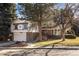 Charming two-story home with brick accents, a well-manicured lawn, and mature trees at 3752 S Rosemary Way, Denver, CO 80237