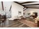 Elegant living room with vaulted ceilings, exposed beams, and hardwood floors at 3752 S Rosemary Way, Denver, CO 80237