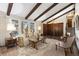 Sunlit living room showcases vaulted ceilings, exposed beams and seamless transition at 3752 S Rosemary Way, Denver, CO 80237