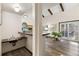 Open living space with wood floors, bar sink, and a sliding door leading to the outdoor patio at 3752 S Rosemary Way, Denver, CO 80237