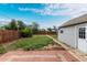 A fenced backyard boasts a patio and detached garage, providing outdoor enjoyment and extra storage at 436 S 4Th Ave, Brighton, CO 80601