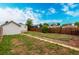 View of a backyard with detached garage and wooden fence at 436 S 4Th Ave, Brighton, CO 80601