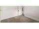 View into neutral bedroom with carpet, and adjacent room with dark red curtains at 436 S 4Th Ave, Brighton, CO 80601