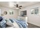 Bright bedroom featuring plush carpeting, a ceiling fan, and a large dresser beneath a mounted television at 436 S 4Th Ave, Brighton, CO 80601