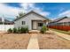 Charming single-story home with gravel front yard and inviting walkway to the front door at 436 S 4Th Ave, Brighton, CO 80601