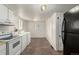Bright eat-in kitchen with white appliances, white cabinets, and linoleum flooring at 436 S 4Th Ave, Brighton, CO 80601