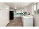 Kitchen area featuring linoleum floors, white cabinets, black refrigerator and a window at 436 S 4Th Ave, Brighton, CO 80601