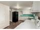 Kitchen area featuring linoleum floors, white cabinets, black refrigerator and a window at 436 S 4Th Ave, Brighton, CO 80601