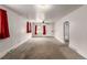 Bright living room with carpet, featuring white walls, ceiling fan, and large windows at 436 S 4Th Ave, Brighton, CO 80601