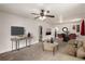Bright living room features modern decor, carpeted floors, and a ceiling fan at 436 S 4Th Ave, Brighton, CO 80601