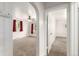 View through archway into carpeted living room with bright windows at 436 S 4Th Ave, Brighton, CO 80601
