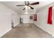Spacious living room with neutral carpet, ceiling fan, and archway leading to other rooms at 436 S 4Th Ave, Brighton, CO 80601