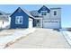 Two-story home with blue and gray siding, attached garage, and landscaping at 39440 Congress Ln, Elizabeth, CO 80107