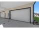 Modern garage with white door and ample parking space at 5098 E Donald, Denver, CO 80222