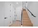 Modern light wood staircase with black metal railing at 5098 E Donald, Denver, CO 80222