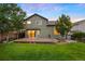 Spacious backyard with lush lawn, a charming deck, and mature landscaping providing a private oasis at 777 Whispering Oak Dr, Castle Rock, CO 80104