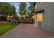 Backyard deck perfect for outdoor enjoyment with grassy area, privacy fence and mature trees at 777 Whispering Oak Dr, Castle Rock, CO 80104