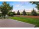Large backyard with a well-maintained lawn, a wooden deck, and privacy landscaping at 777 Whispering Oak Dr, Castle Rock, CO 80104